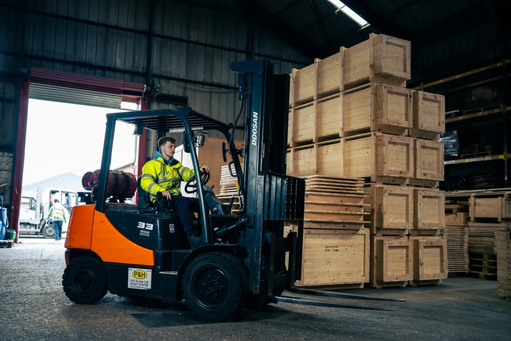 Driver of forklift truck with export packages
